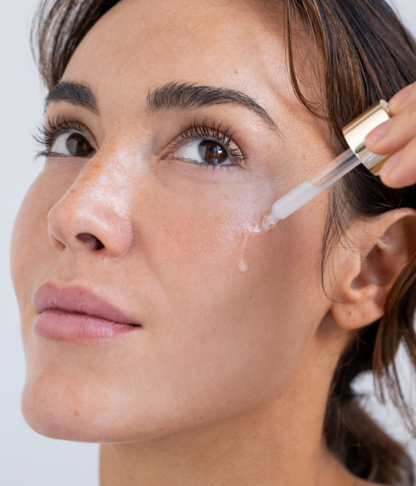 women holding white serum