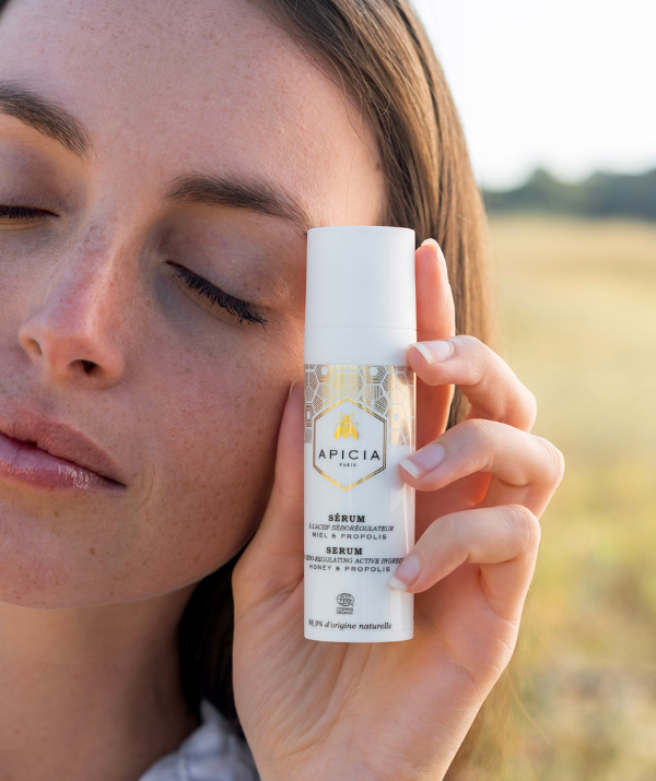 women holding white serum