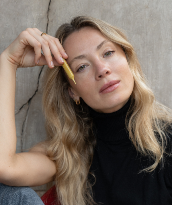 women holding a yellow vial
