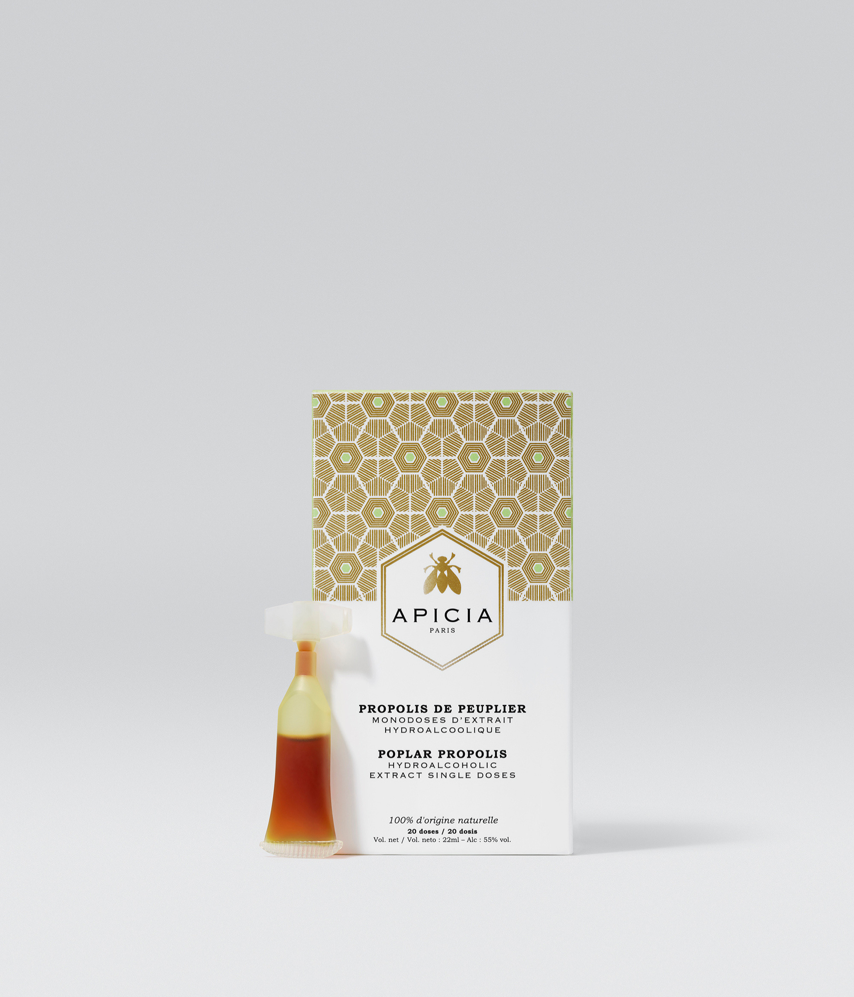 Packshot d'une boîte blanche et dorée contenant des monodoses de propolis sur un fond gris.
